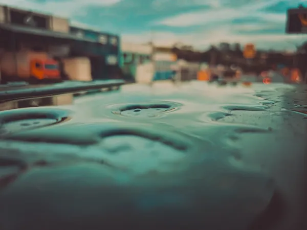 Urban Raindrops on Reflective Surface